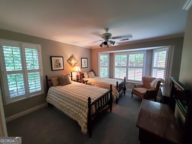 1030 Lake Haynes Dr NE, Conyers, GA 30012 - bedroom with crown molding, ceiling fan, dark carpet, baseboards, and visible vents
