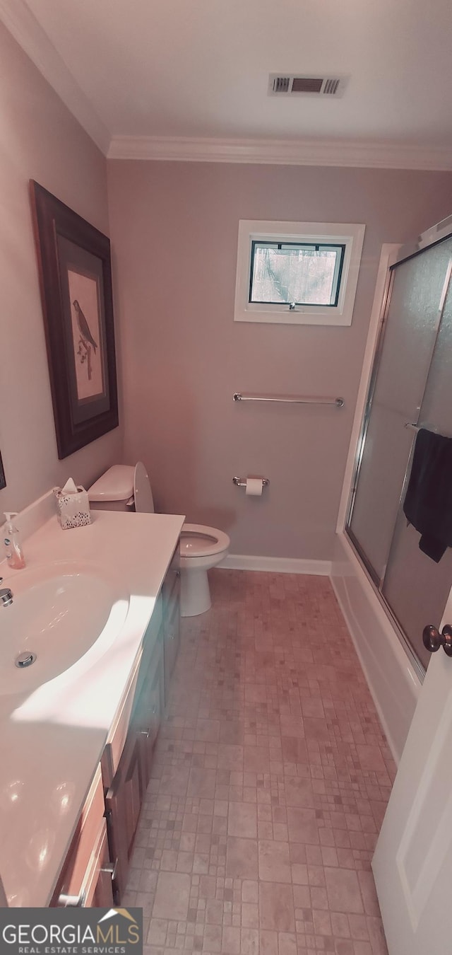 full bathroom with crown molding, toilet, vanity, and combined bath / shower with glass door