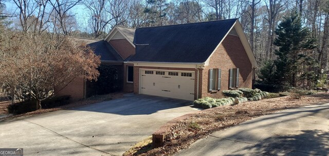1030 Lake Haynes Dr NE, Conyers, GA 30012 - view of home's exterior featuring brick siding, a garage, and concrete driveway