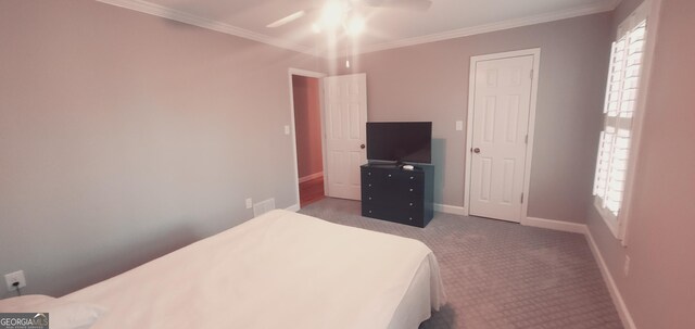 bedroom with ceiling fan, crown molding, and carpet