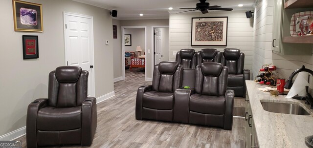1030 Lake Haynes Dr NE, Conyers, GA 30012 - cinema room with light wood-type flooring, a ceiling fan, baseboards, and a sink