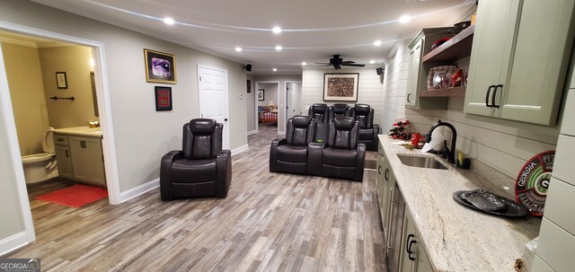 1030 Lake Haynes Dr NE, Conyers, GA 30012 - home theater room featuring light wood-style flooring, baseboards, a sink, and a ceiling fan