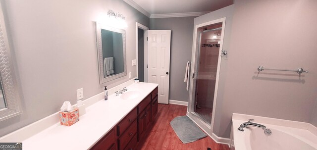 1030 Lake Haynes Dr NE, Conyers, GA 30012 - bathroom with a garden tub, wood finished floors, a stall shower, vanity, and ornamental molding