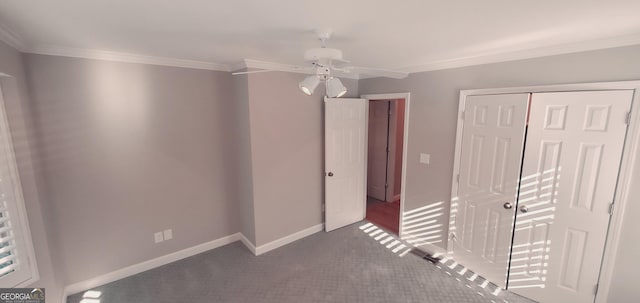 1030 Lake Haynes Dr NE, Conyers, GA 30012 - unfurnished bedroom featuring baseboards, a closet, ceiling fan, crown molding, and carpet floors