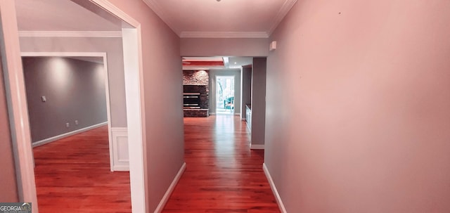 corridor featuring hardwood / wood-style flooring and crown molding