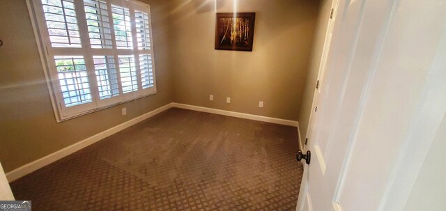 1030 Lake Haynes Dr NE, Conyers, GA 30012 - unfurnished room with dark carpet and baseboards