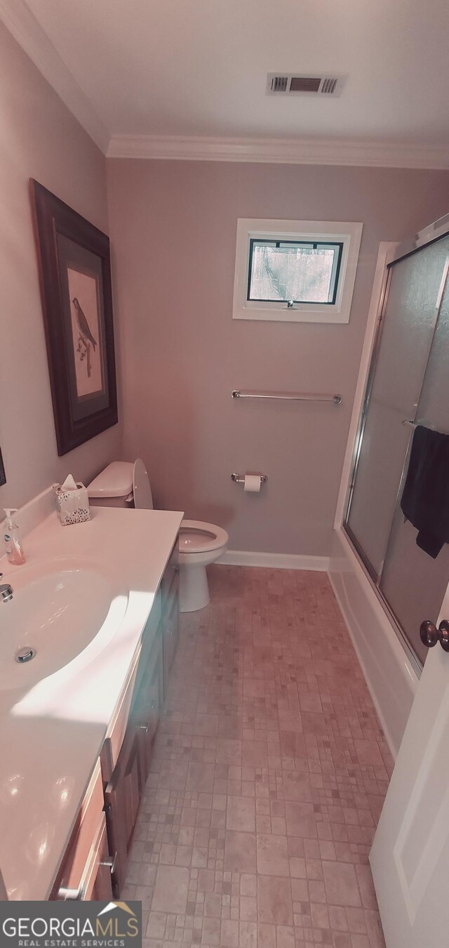 1030 Lake Haynes Dr NE, Conyers, GA 30012 - bathroom featuring brick patterned floor, visible vents, toilet, vanity, and crown molding