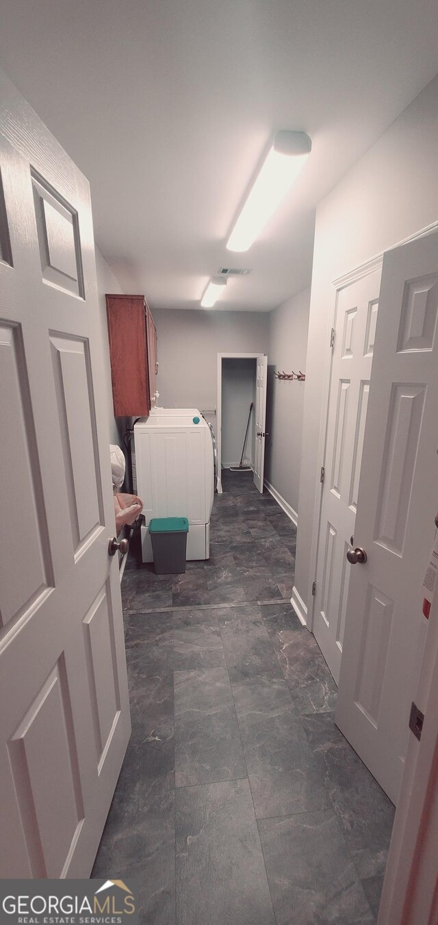 1030 Lake Haynes Dr NE, Conyers, GA 30012 - laundry room with washing machine and dryer and cabinet space