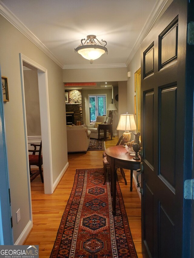 1030 Lake Haynes Dr NE, Conyers, GA 30012 - hall featuring light wood-style flooring, baseboards, and crown molding