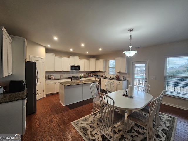 dining room with dark hardwood / wood-style floors