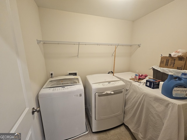 clothes washing area with washer and clothes dryer