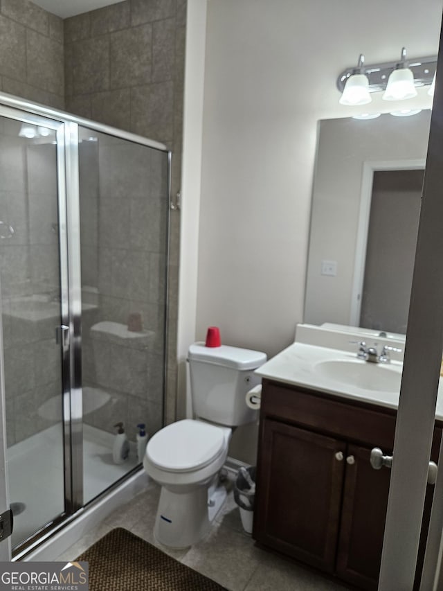 bathroom with walk in shower, vanity, tile patterned flooring, and toilet