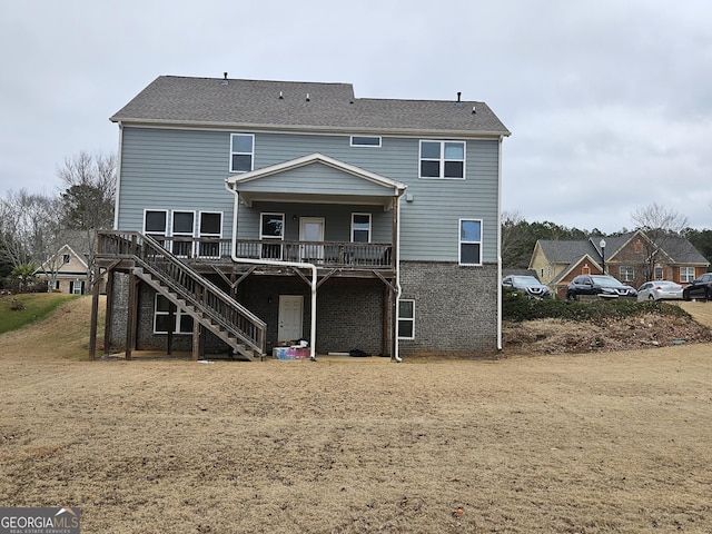 rear view of property featuring a deck