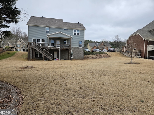 back of house with a lawn and a wooden deck