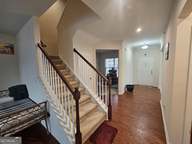 foyer featuring dark hardwood / wood-style floors and ornamental molding