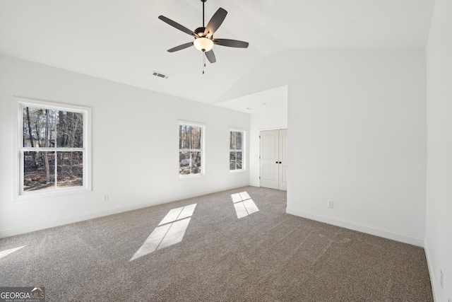 carpeted spare room with vaulted ceiling and ceiling fan