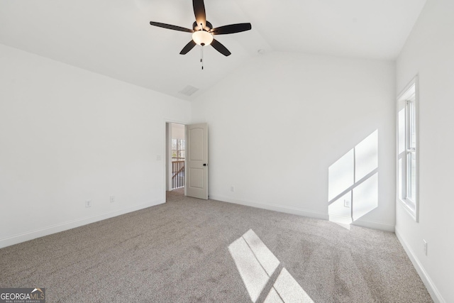 carpeted empty room with high vaulted ceiling and ceiling fan