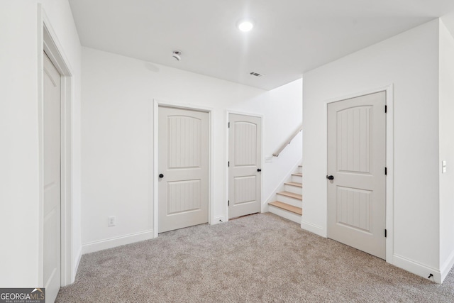 unfurnished bedroom with light colored carpet