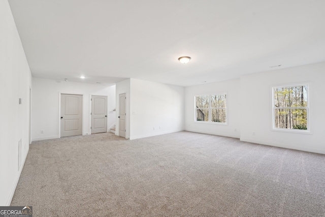 carpeted empty room with a wealth of natural light