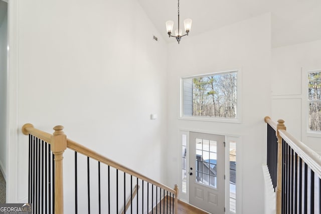 foyer with lofted ceiling and a notable chandelier