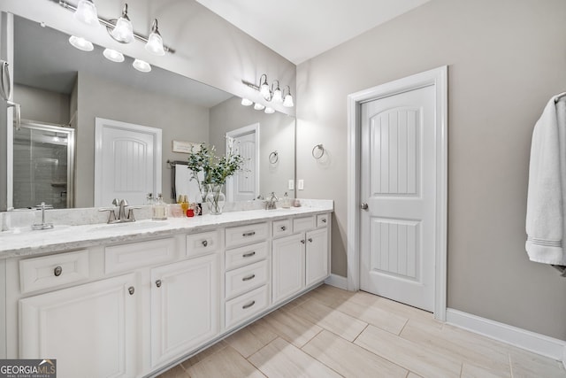 bathroom featuring an enclosed shower and vanity