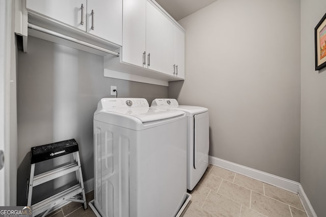 clothes washing area with cabinets and independent washer and dryer