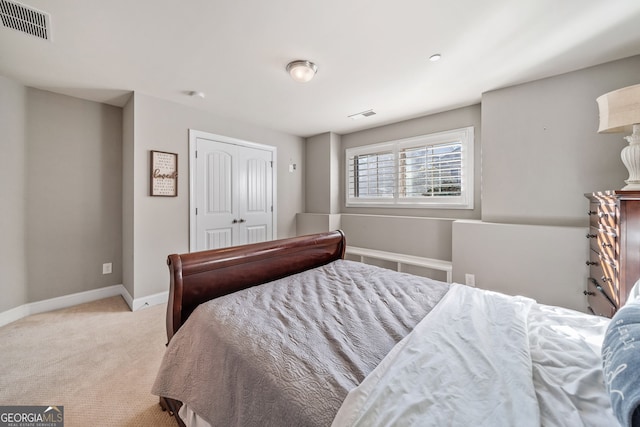 bedroom featuring a closet and light carpet