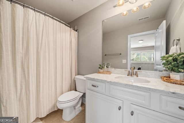 bathroom featuring toilet, vanity, and tile patterned floors