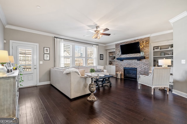 living room featuring a fireplace, ornamental molding, and plenty of natural light