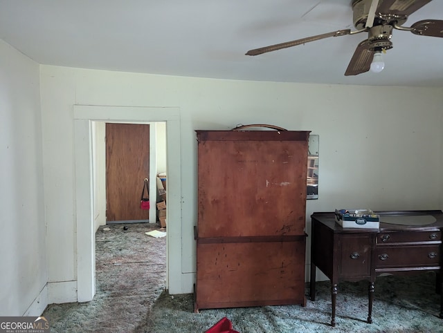 interior space with ceiling fan and dark carpet