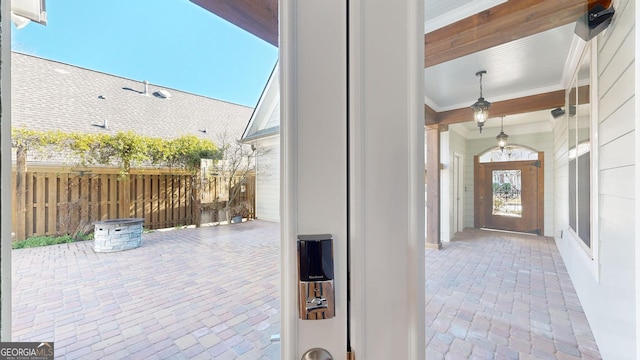 doorway to outside featuring plenty of natural light and ornamental molding