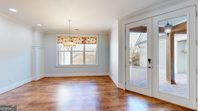 unfurnished dining area featuring ornamental molding, a wealth of natural light, and french doors