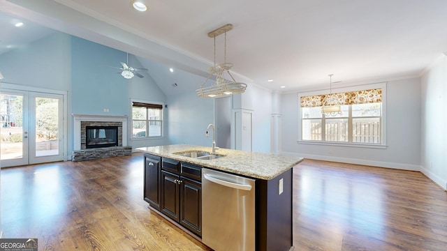 kitchen featuring ceiling fan, dishwasher, sink, pendant lighting, and a center island with sink