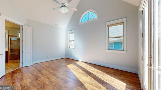 spare room featuring hardwood / wood-style flooring, ceiling fan, and high vaulted ceiling