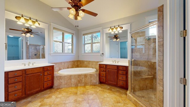 bathroom featuring ceiling fan, vanity, lofted ceiling, and shower with separate bathtub