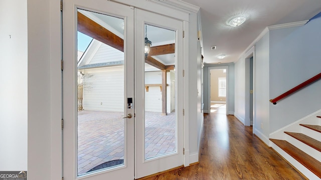 doorway featuring french doors, dark wood-type flooring, and crown molding