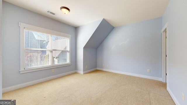 additional living space with light colored carpet