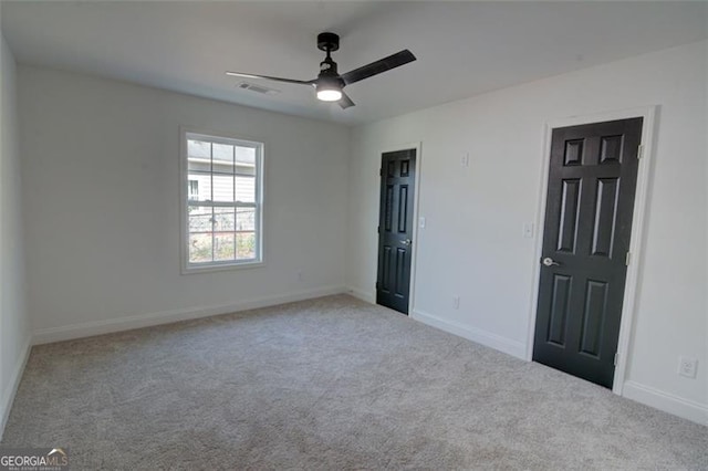 carpeted empty room featuring ceiling fan