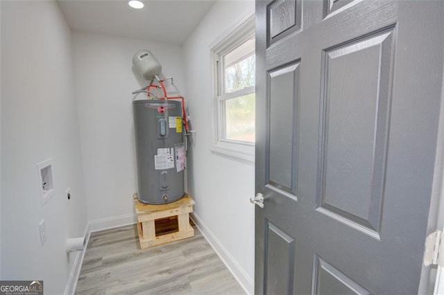 utility room featuring electric water heater