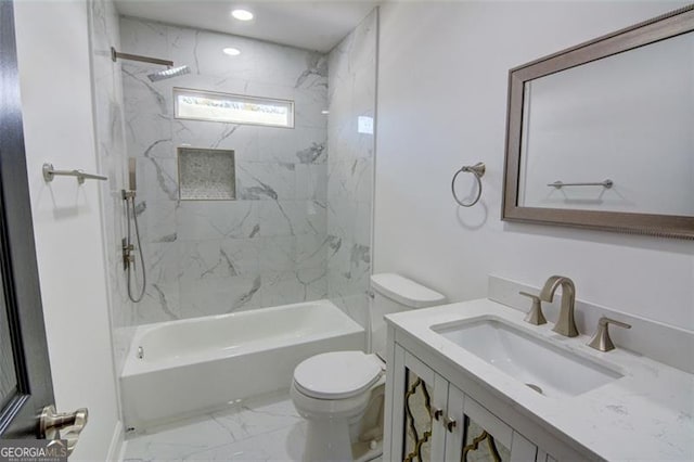 full bathroom with toilet, vanity, and tiled shower / bath combo