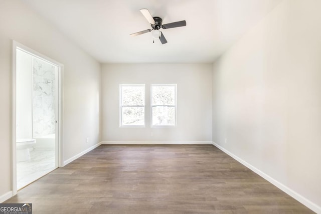 unfurnished room with ceiling fan and hardwood / wood-style floors