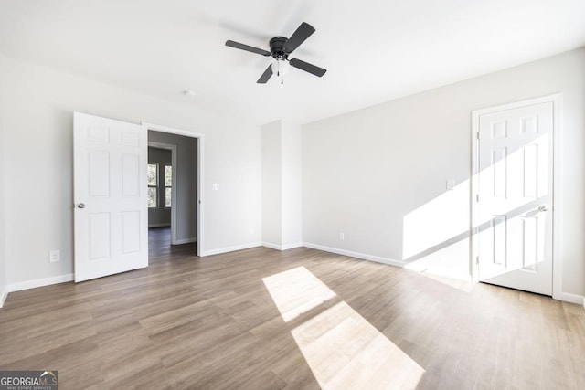 empty room featuring ceiling fan and light hardwood / wood-style floors