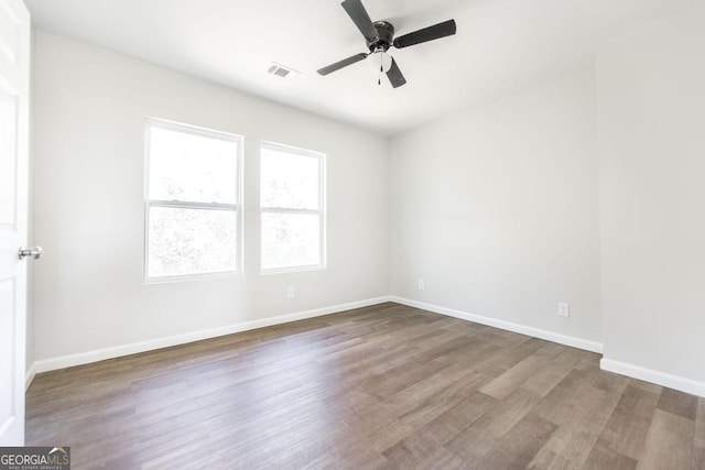 empty room with ceiling fan and hardwood / wood-style floors