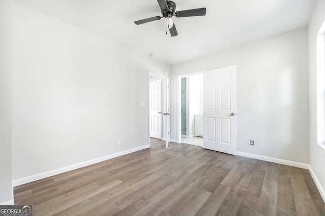 unfurnished bedroom featuring ceiling fan and light hardwood / wood-style flooring