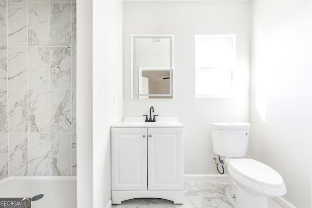 bathroom with toilet, a tile shower, and vanity