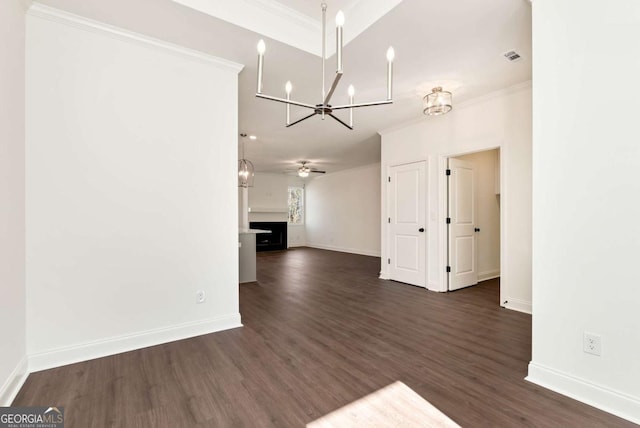 unfurnished living room with ceiling fan, dark hardwood / wood-style flooring, and ornamental molding