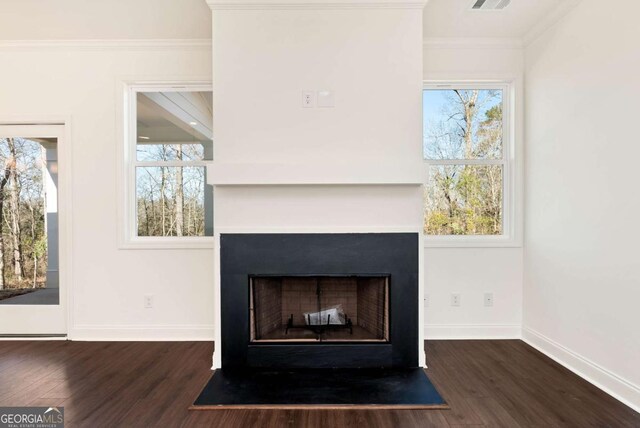 interior details with hardwood / wood-style floors and crown molding