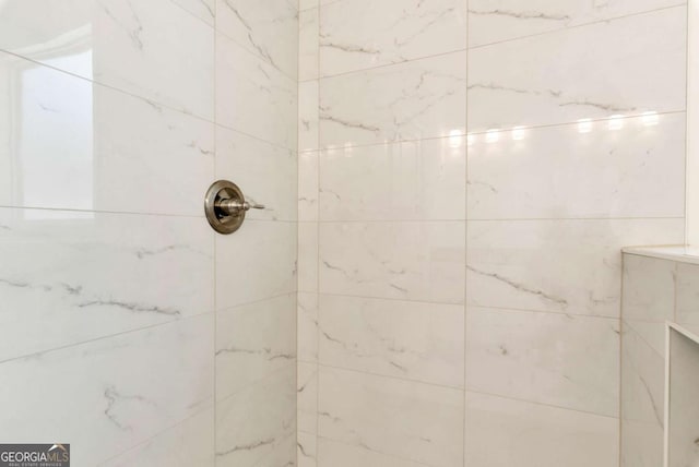 bathroom with tiled shower