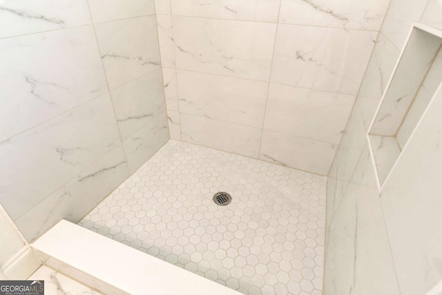 bathroom with a tile shower