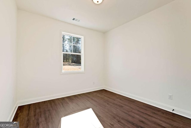 spare room with dark hardwood / wood-style floors